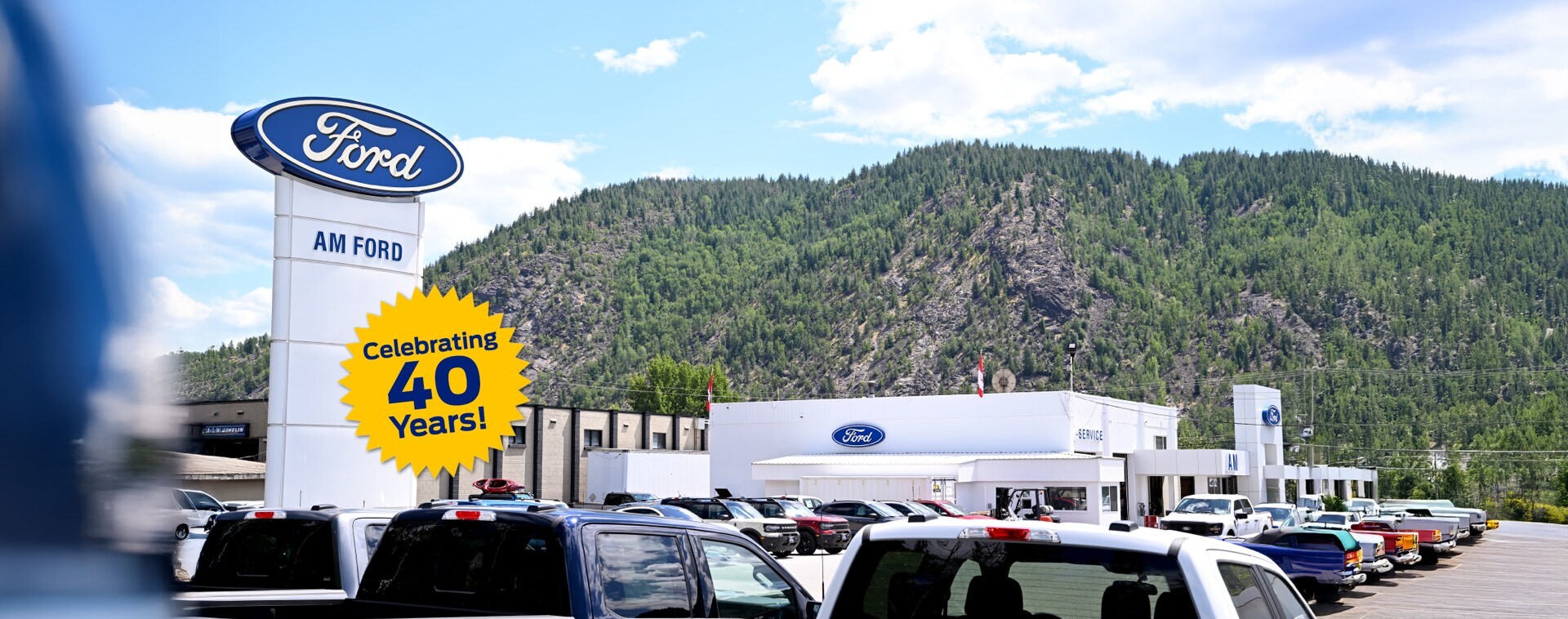 Exterior of the AM Ford building in Trail, B.C. with a starburst design that says “Celebrating 40 years” 