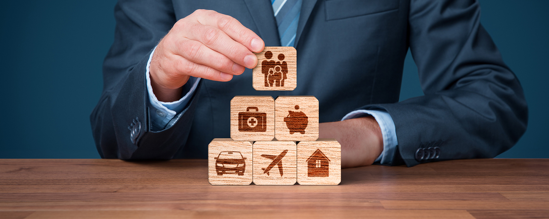 Insurance concept. Blocks with house, car, family, airplane and health symbol on them. 