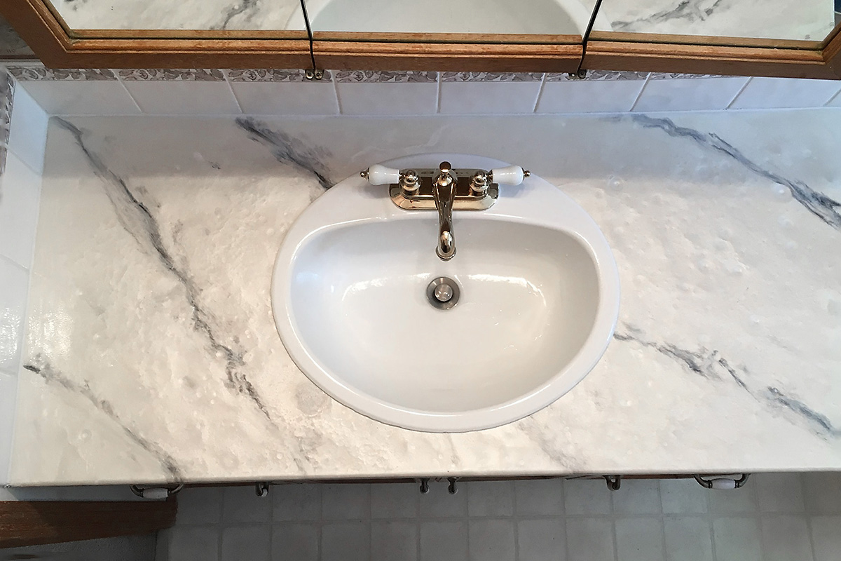 bathroom sink and countertop refinished by ReCoat Renovations 