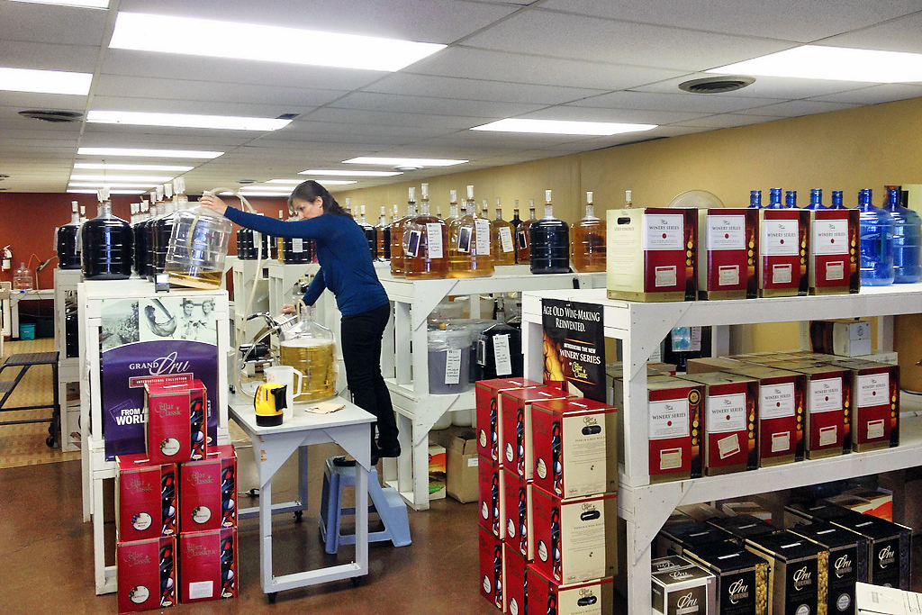 A woman stocking wine of shelves